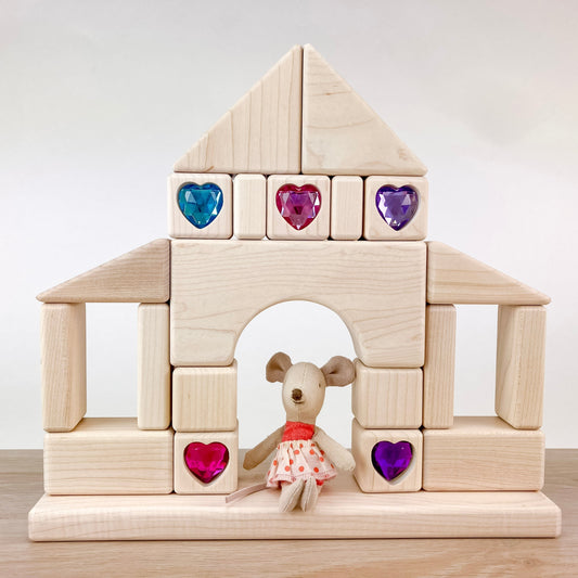 Mouse sitting in house made of blocks